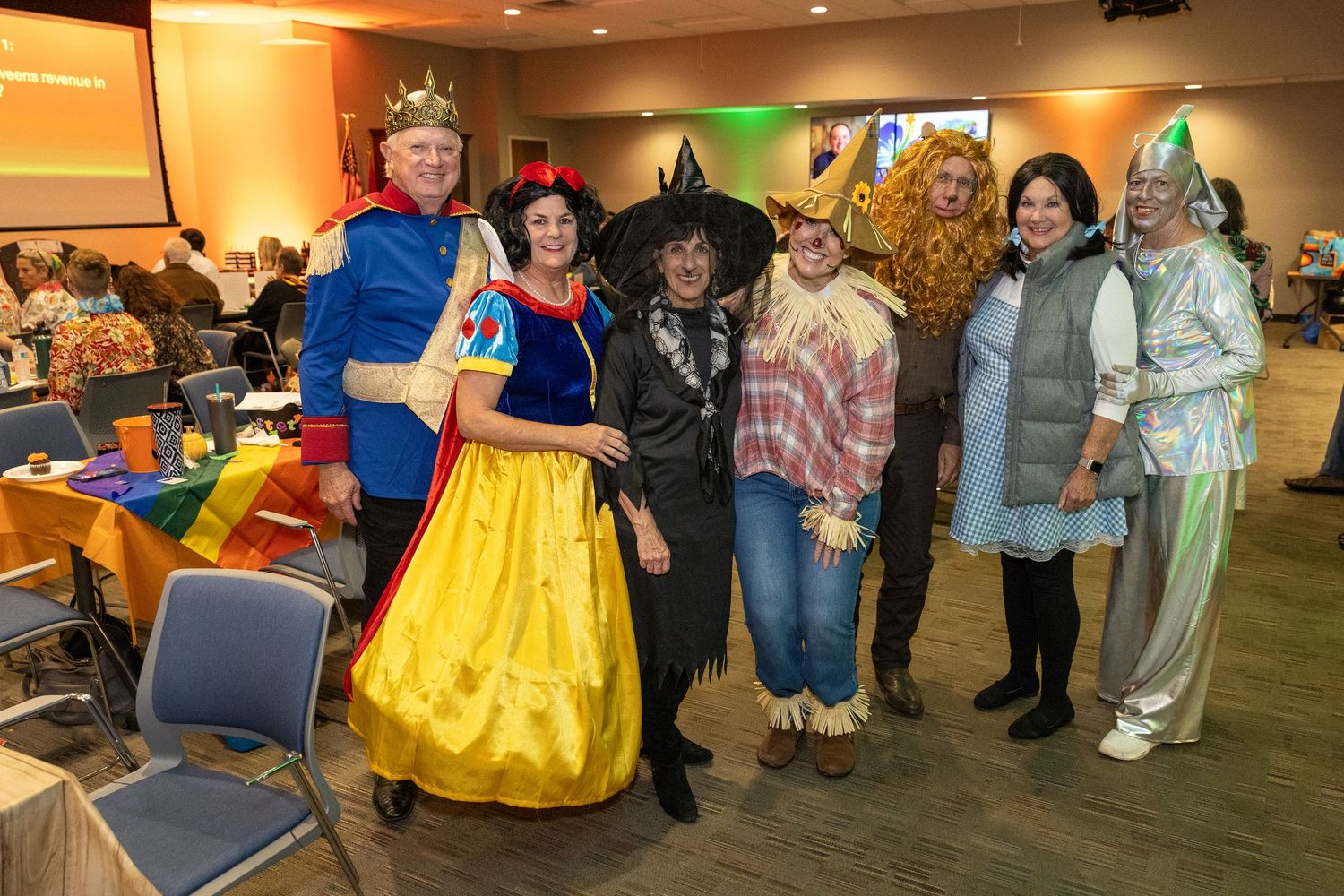 Group photo of people in fairy tale and fantasy costumes at an indoor convention.