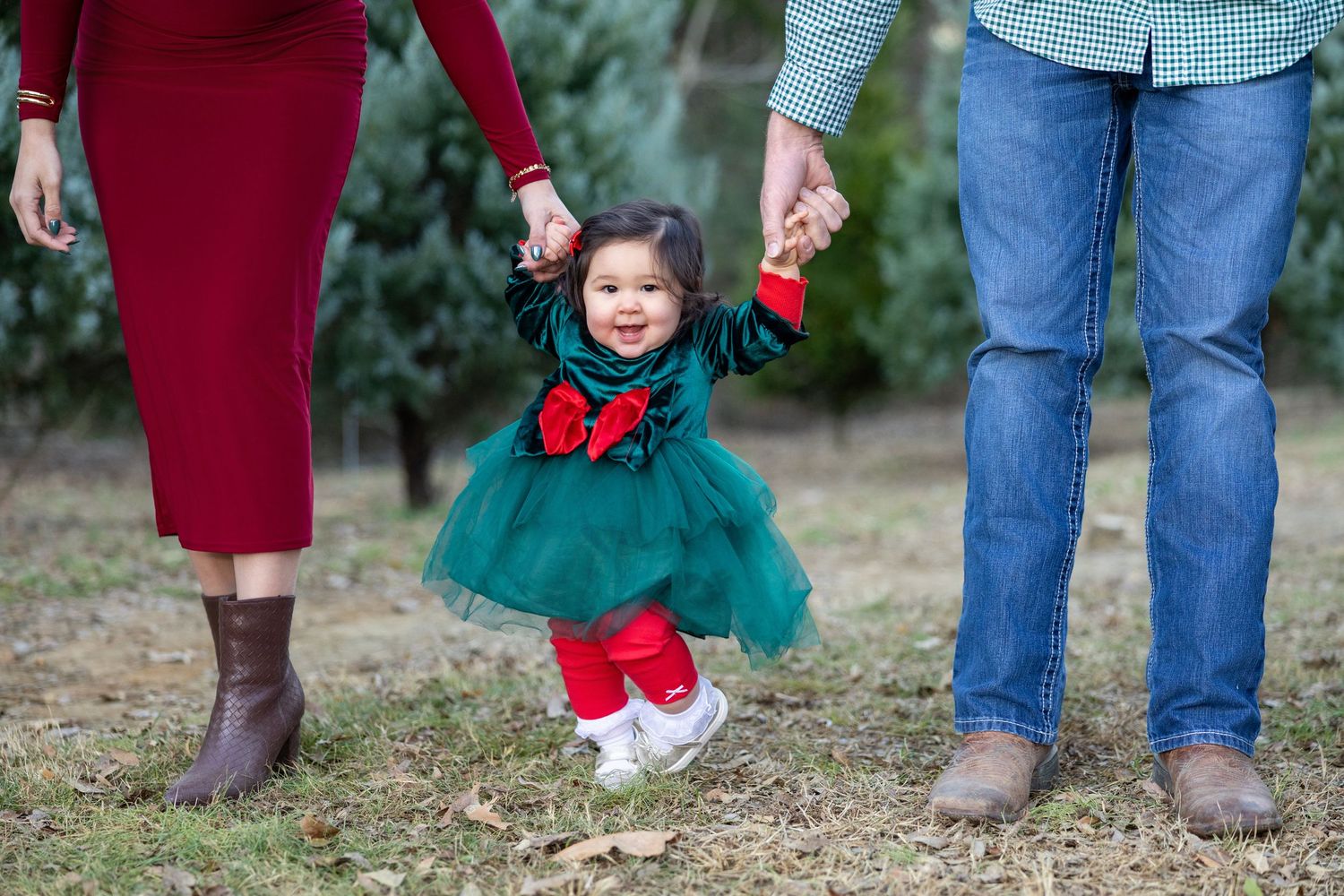 Candid family photo session showing feet and casual poses against natural backdrop.