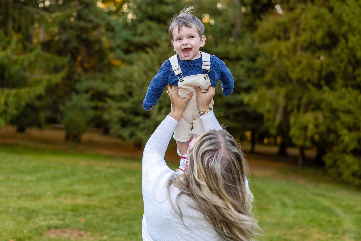 Outdoor autumn photoshoot with playful poses on grass.