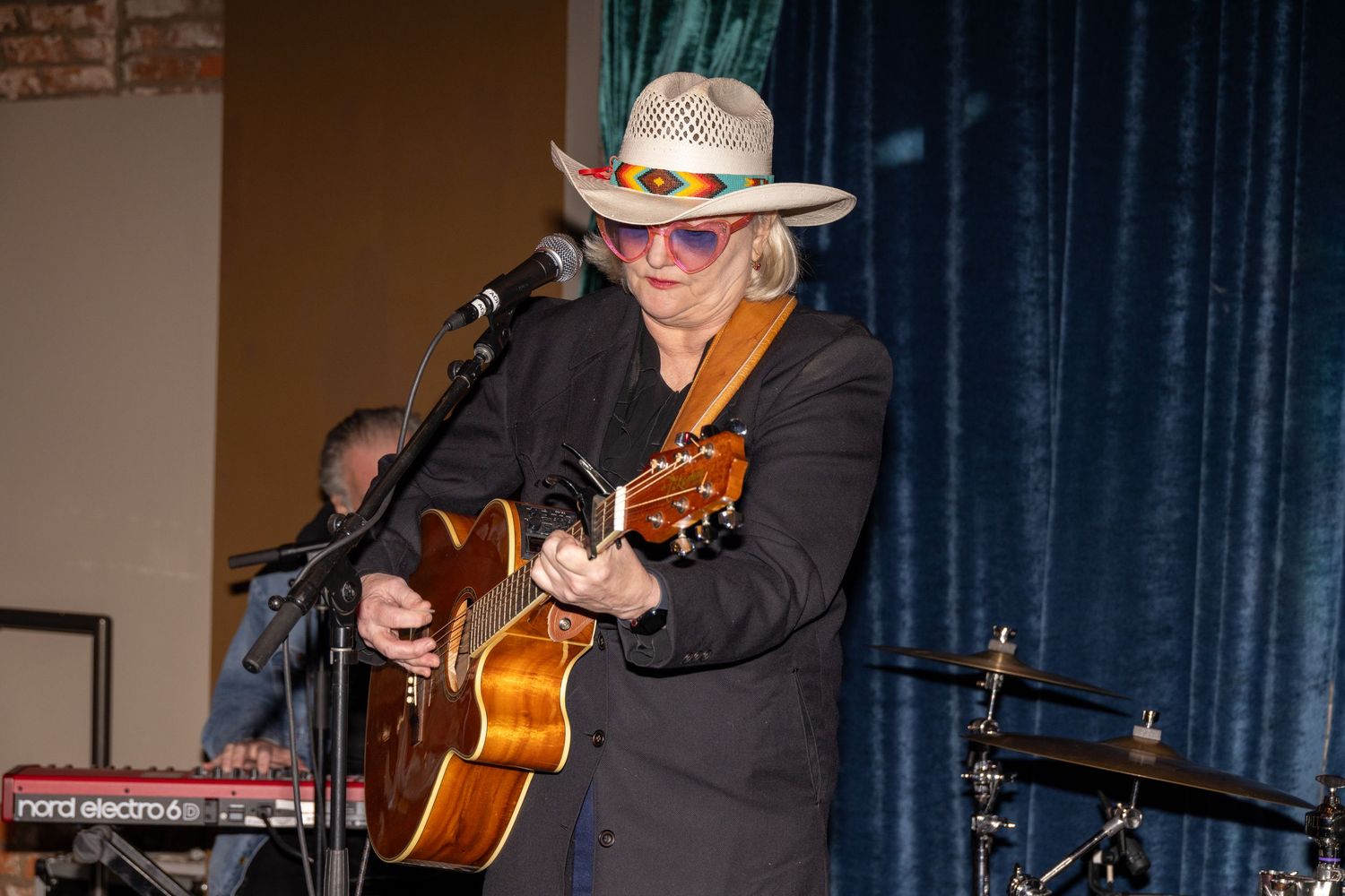 Musicians playing acoustic instruments during intimate venue performance.