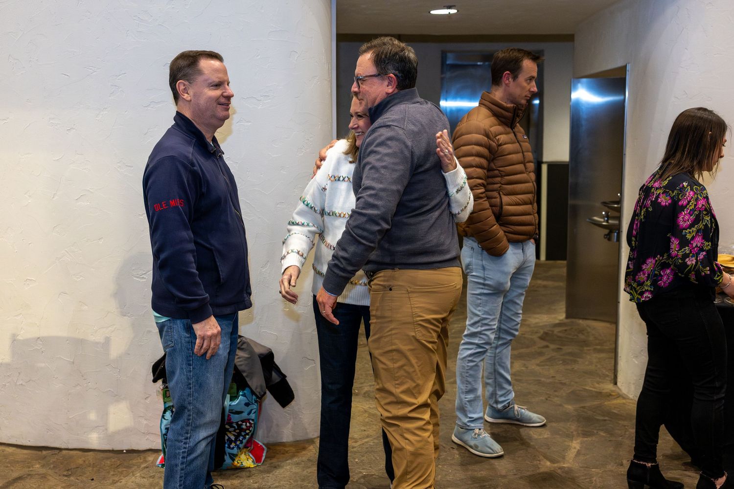 People gathered in a hallway during an indoor event.