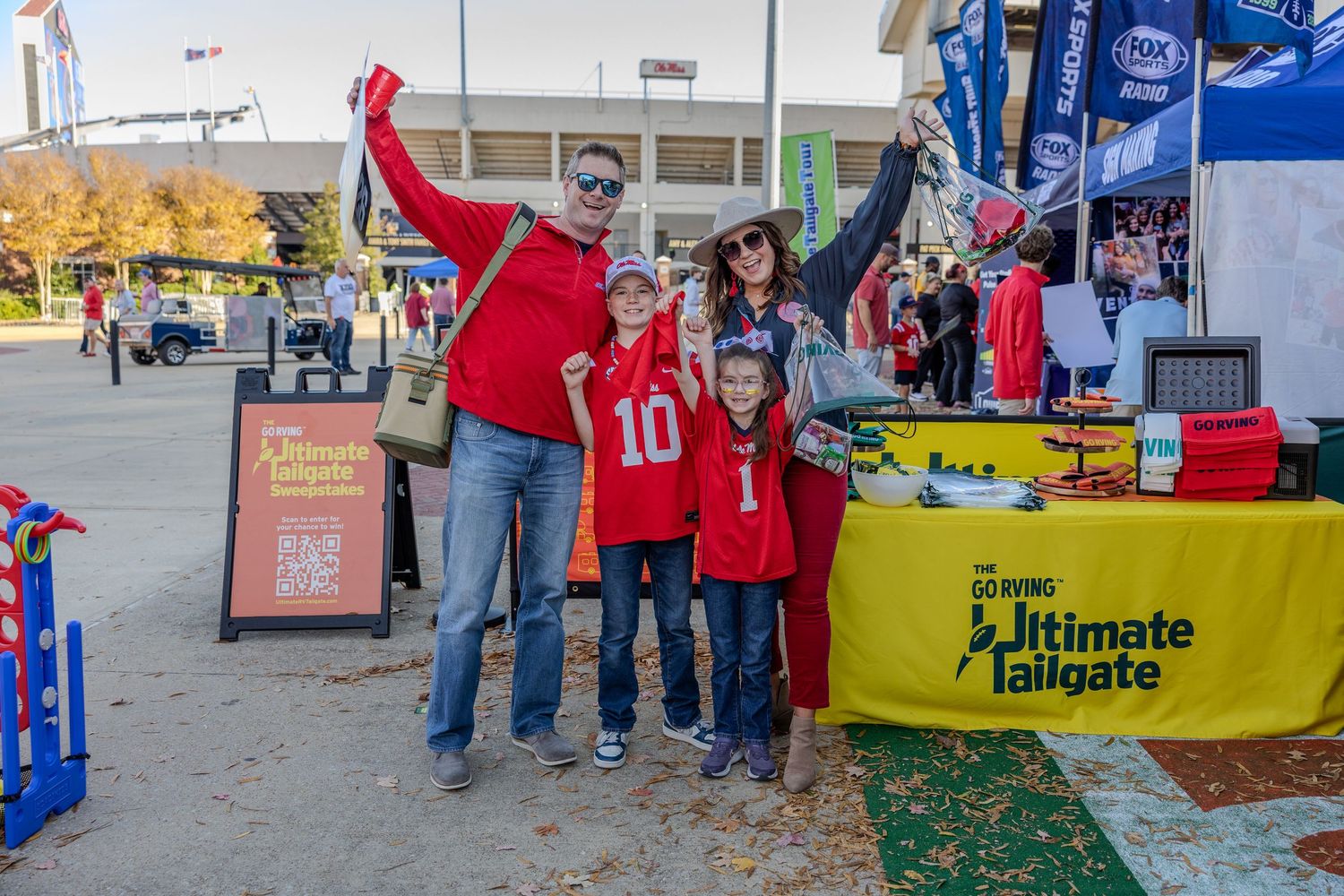 Sports fans gathering outside stadium with team flags and banners on display.