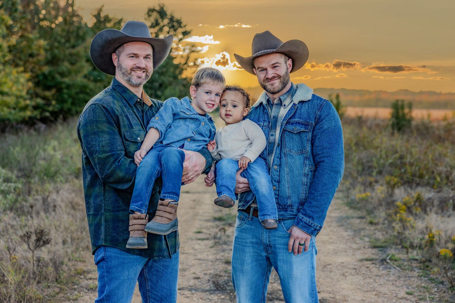 Family portrait session at golden hour in rustic outdoor setting.