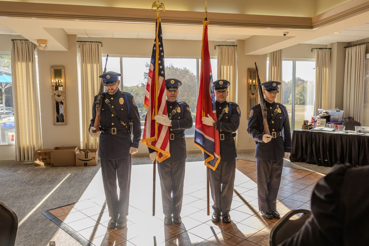 Color guard unit presenting American and state flags in formal ceremony.