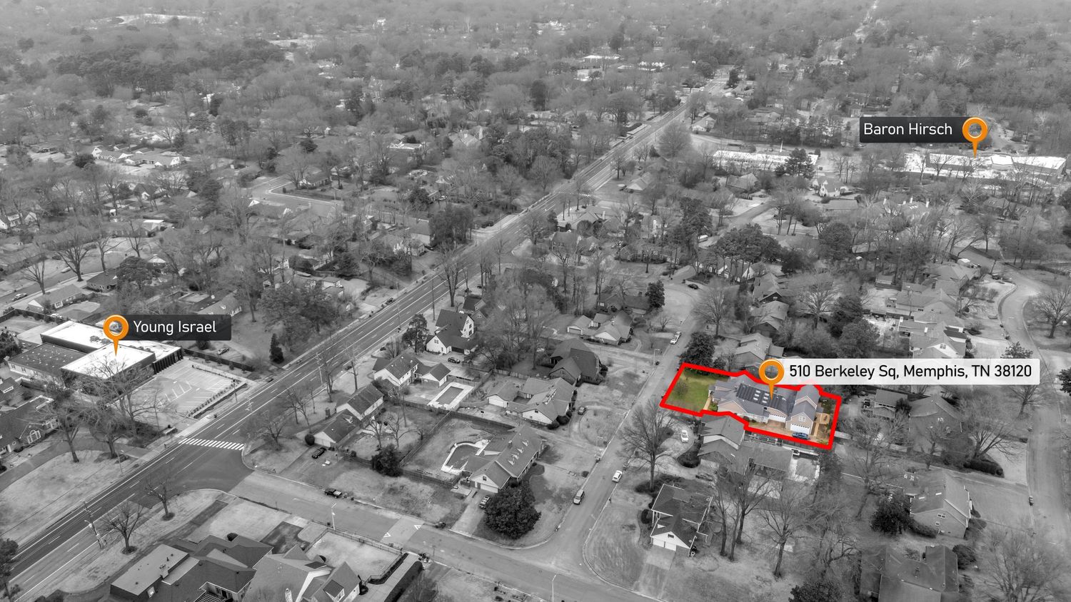 Aerial panoramic view of a suburban neighborhood with residential buildings and streets shown in black and white.