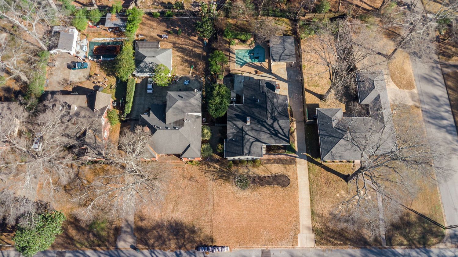 Aerial view of a rustic stone venue with surrounding green landscape and trees.
