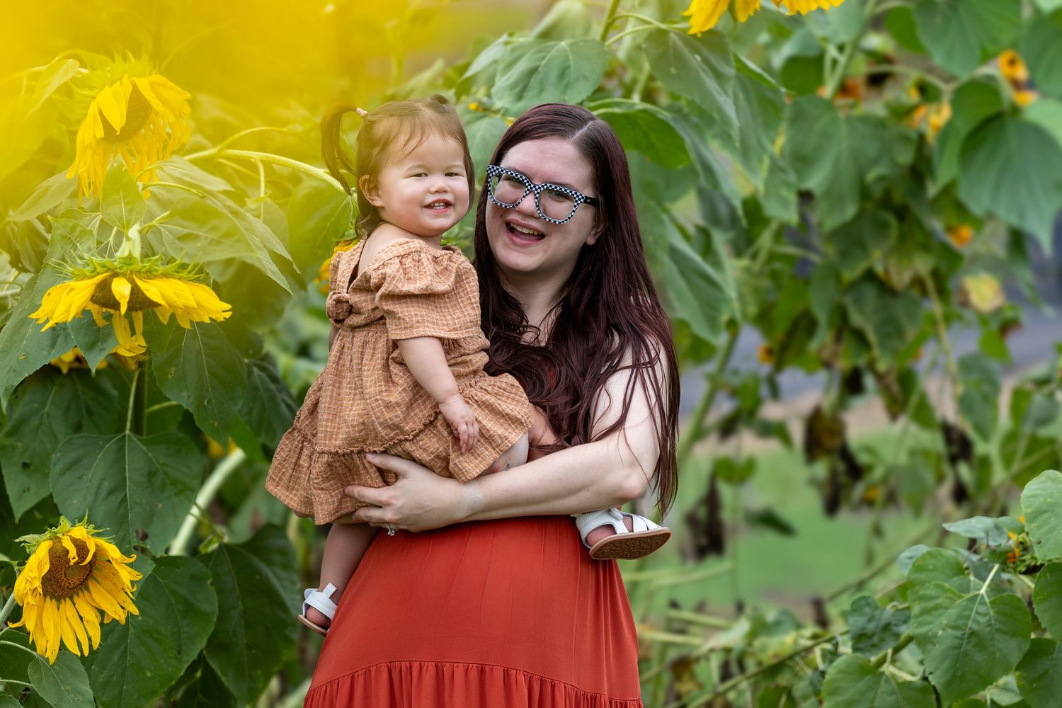 Candid moment captured in a sunflower garden during golden hour.