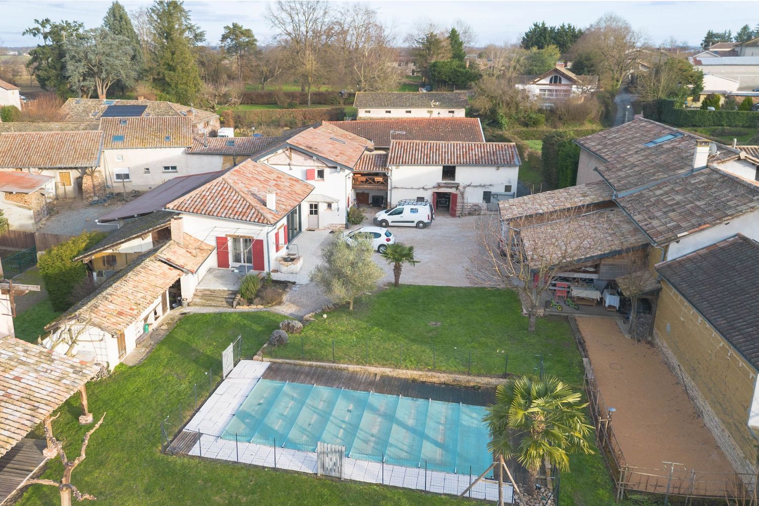 Photographie immobilière par drone à Mâcon : vue aérienne d'une propriété avec piscine et jardin.