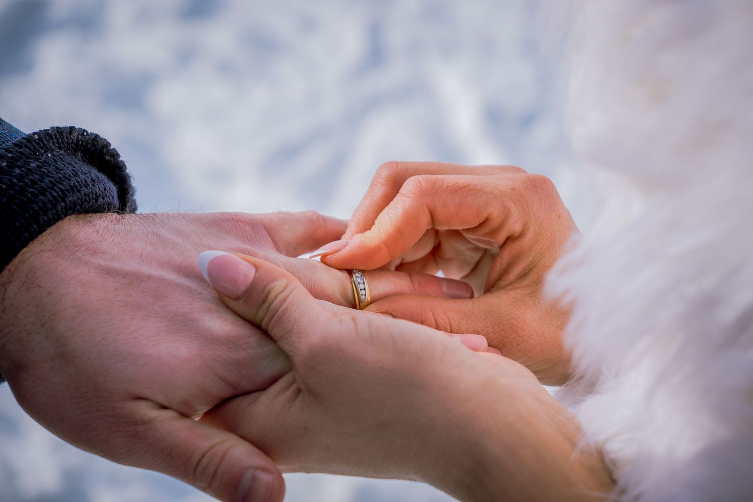 Series of hands exchanging wedding rings during a ceremony against a soft white background.