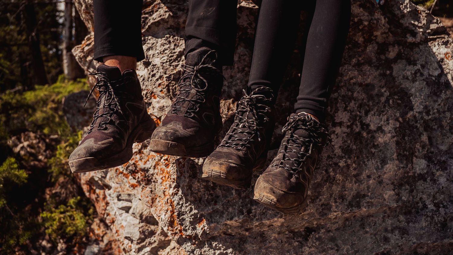 Close-up of hiking boots on rocky mountain terrain during an outdoor adventure.