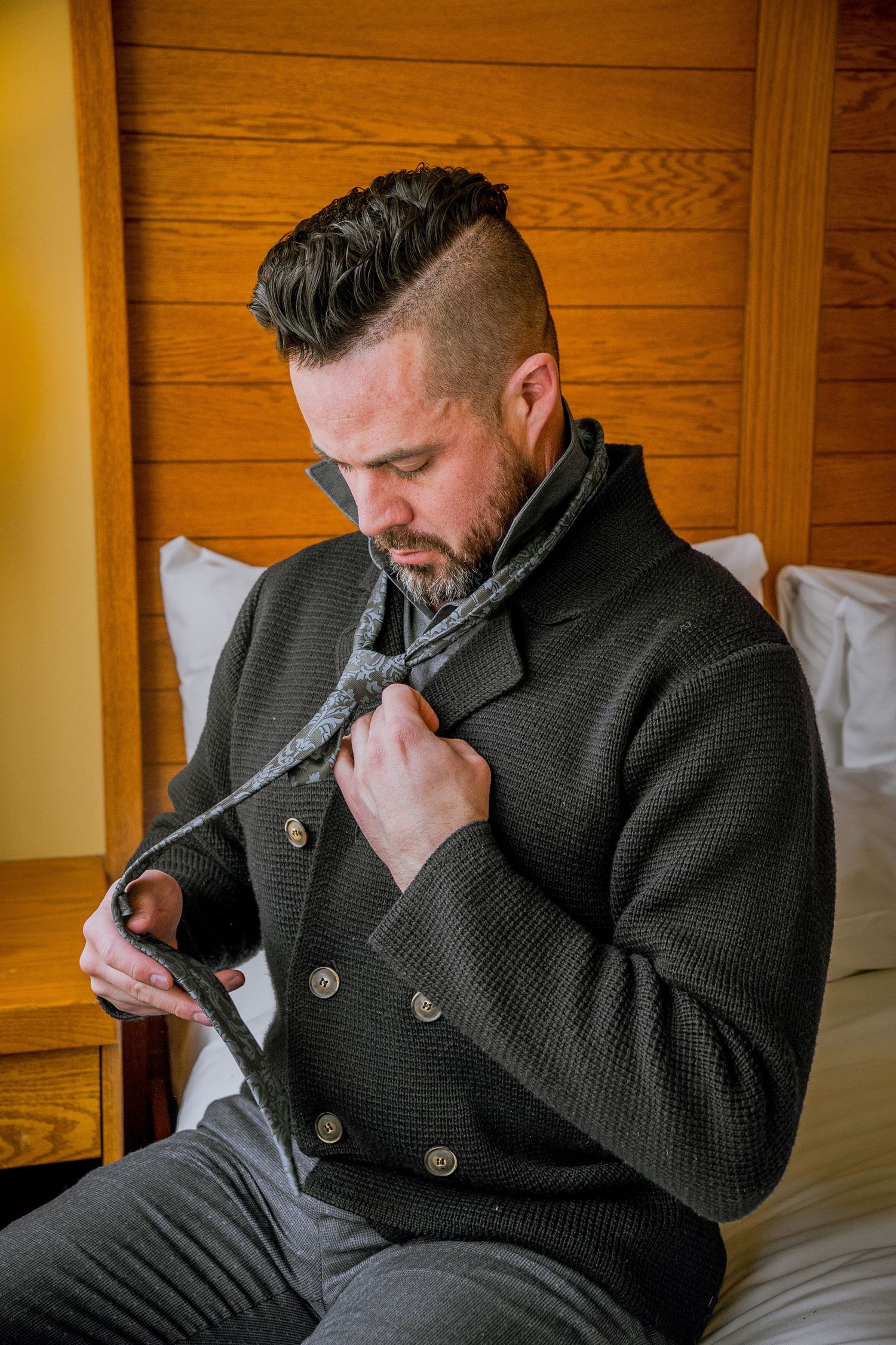 Person in dark sweater sitting on bed taking a series of photos showing emotional distress and concern.