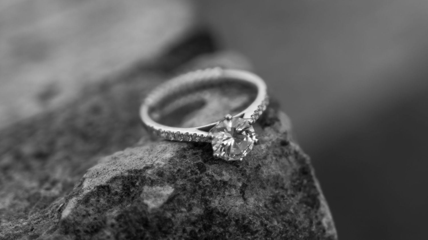 A black and white engagement ring macro photo series showing the diamond ring from multiple artistic angles.