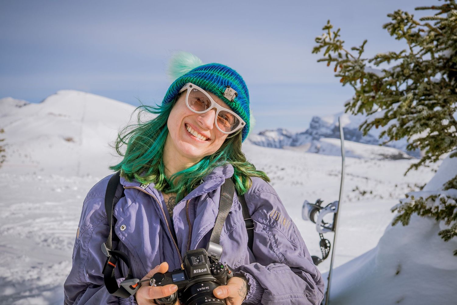 A group of skiers enjoy fresh powder snow while backcountry skiing in a snowy mountain landscape.