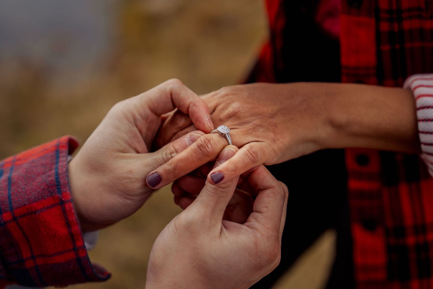 Close-up of hands exchanging rings during an intimate moment.