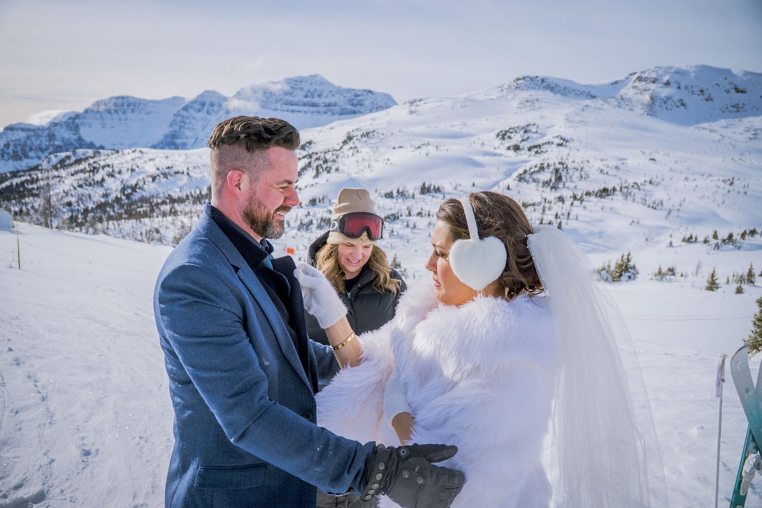 A romantic winter wedding moment captured against a snowy mountain backdrop in the Alps.