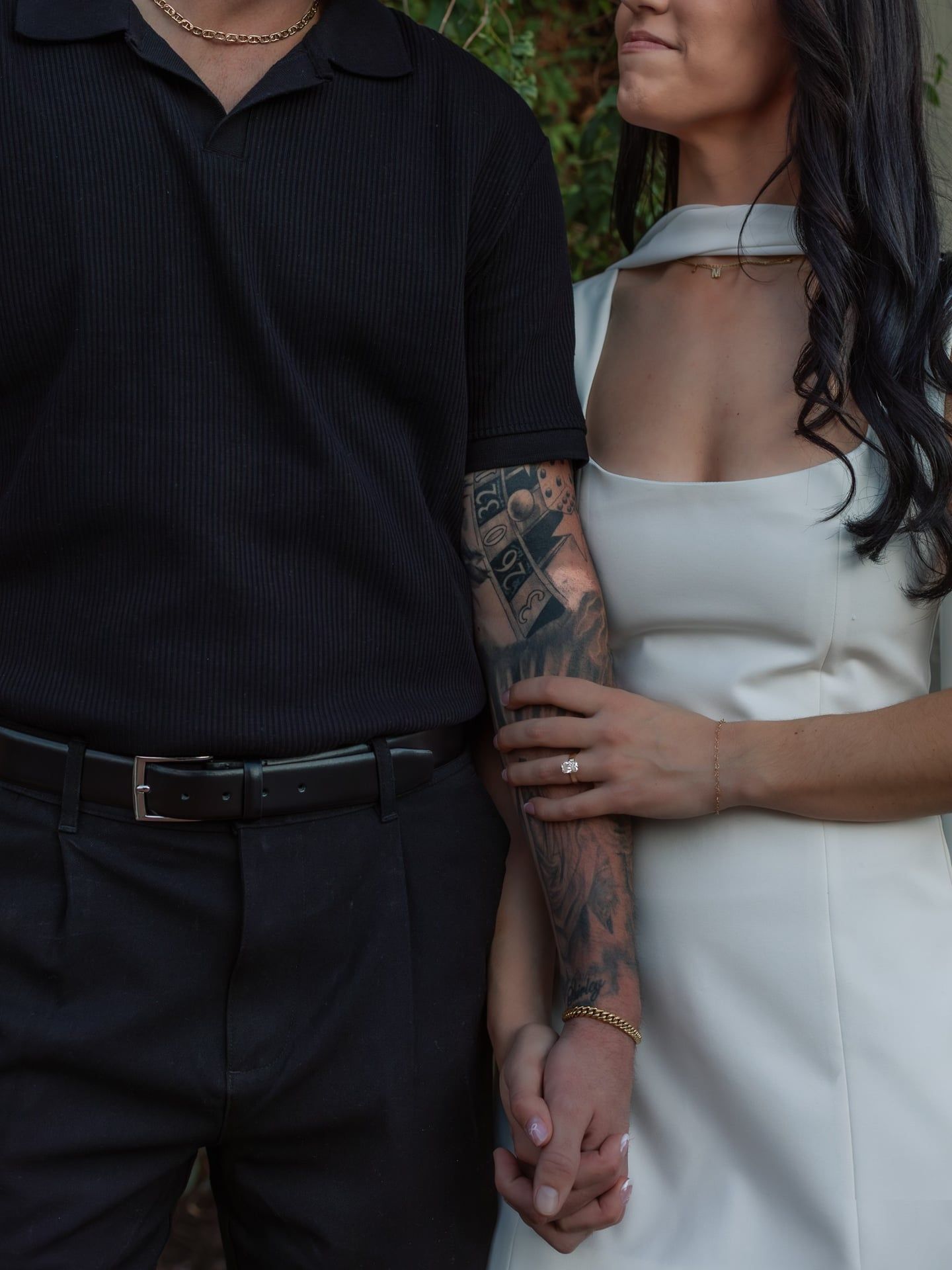 Romantic close-up of couple holding hands and displaying engagement ring during lifestyle photography session