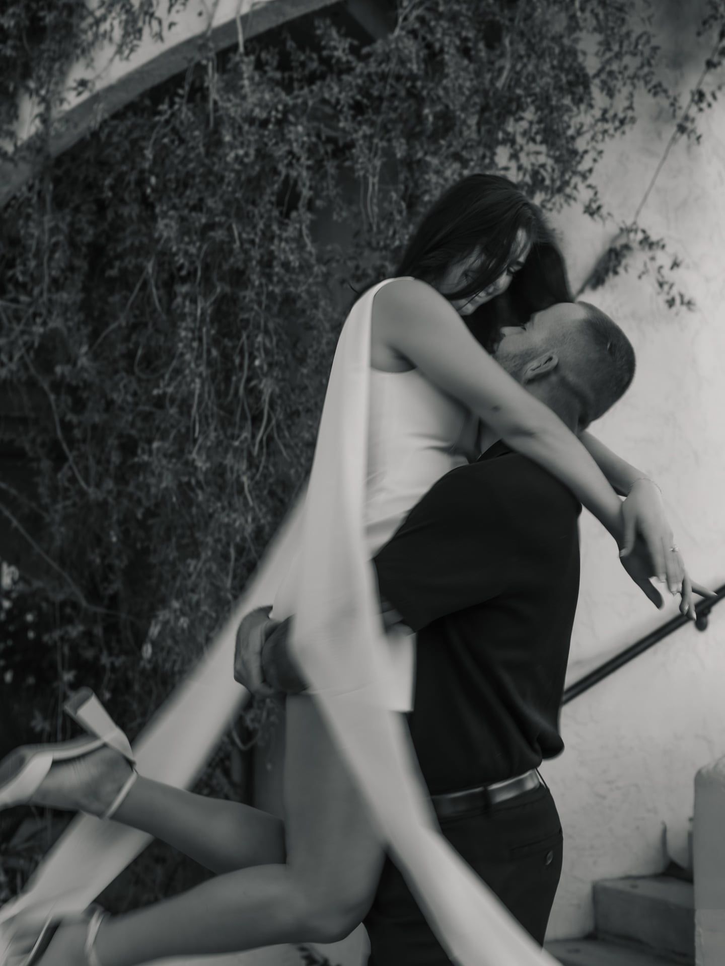 groom picking up bride in engagement shoot black and white spinning cinematic