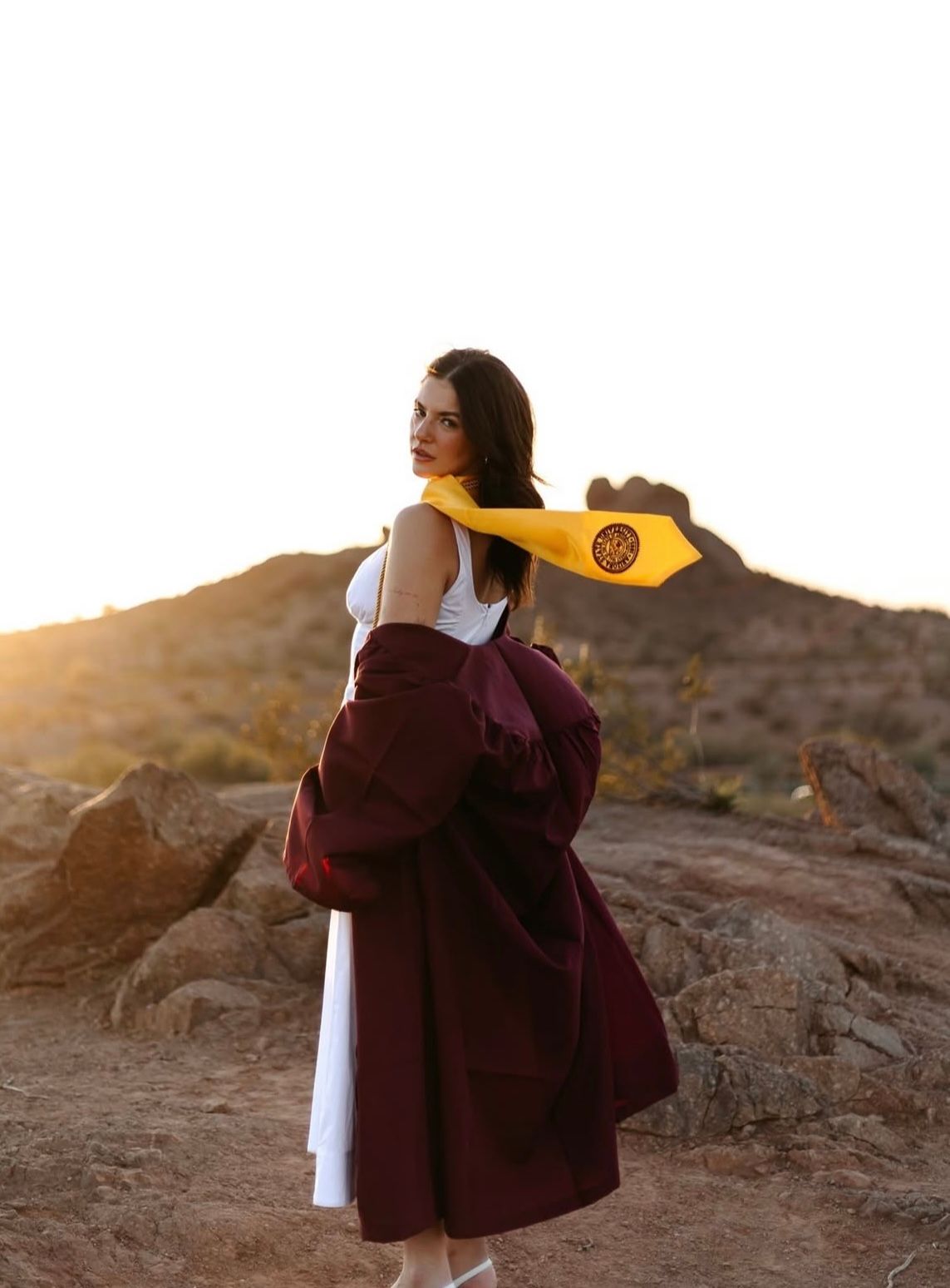 Arizona state graduate photoshoot in the desert with gold hour lighting