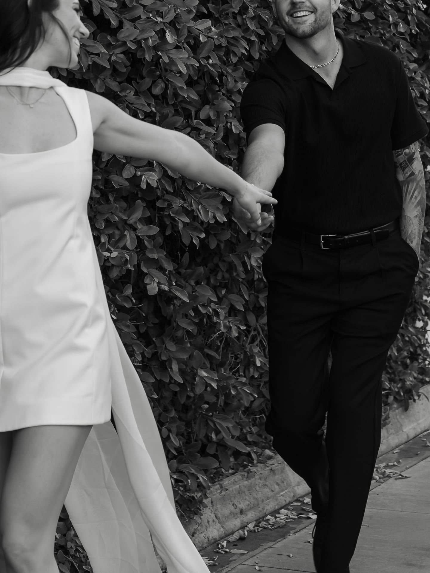 couple holding hands in romantic engagement session by kyleegxphotography