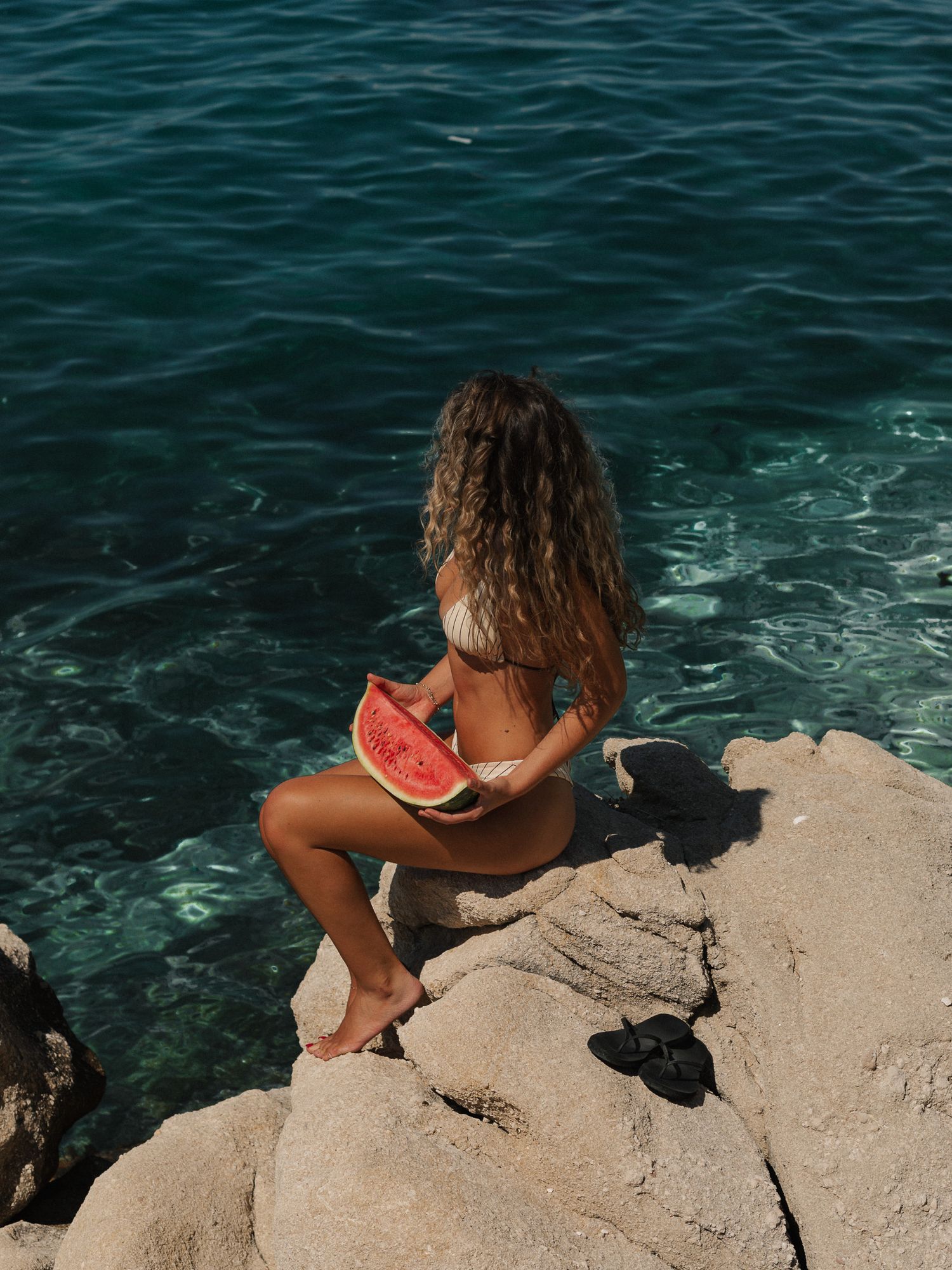 Portrait photo of a woman by the sea at golden hour by Kylee GX Photography