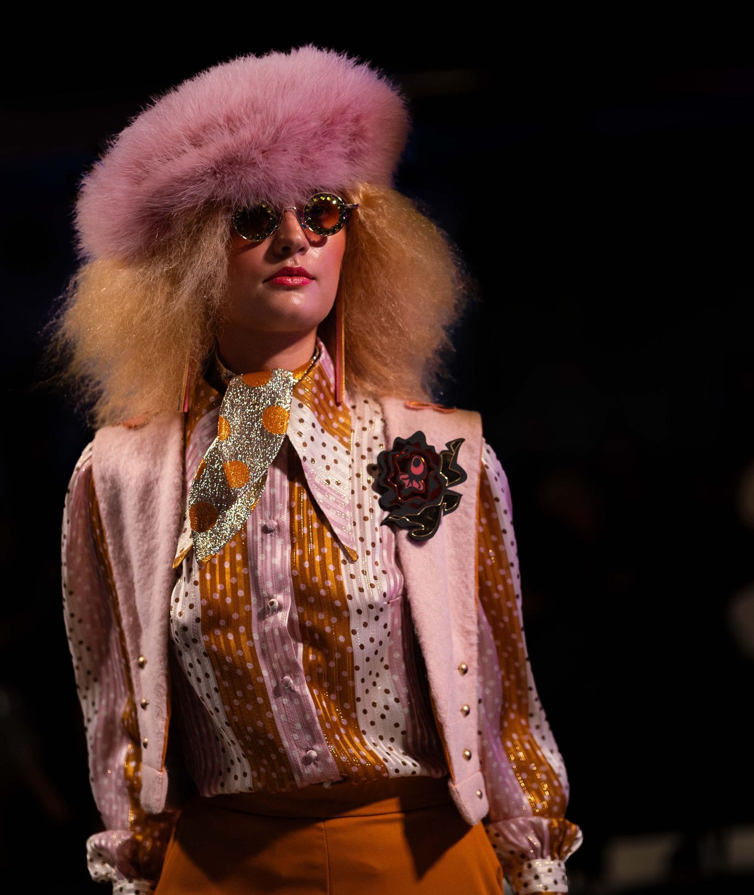 Runway look featuring pink fur, polka dots, and retro sunglasses.