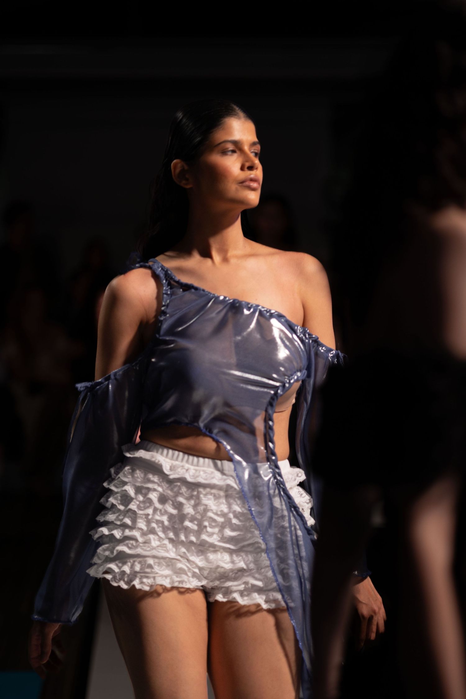 Fashion design featuring blue satin dress with white ruffled details.