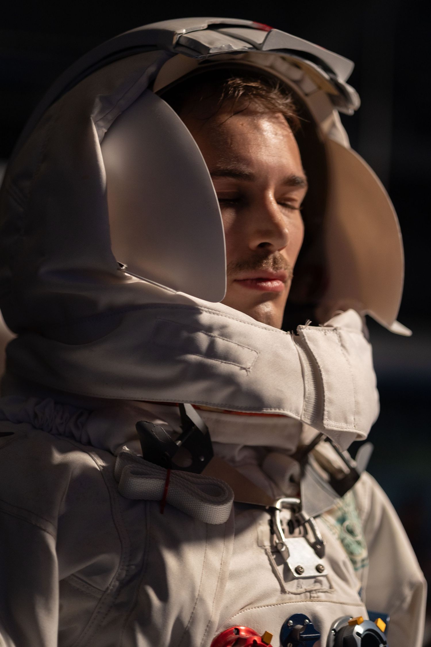 Astronauts in white spacesuits with helmets during a mission.