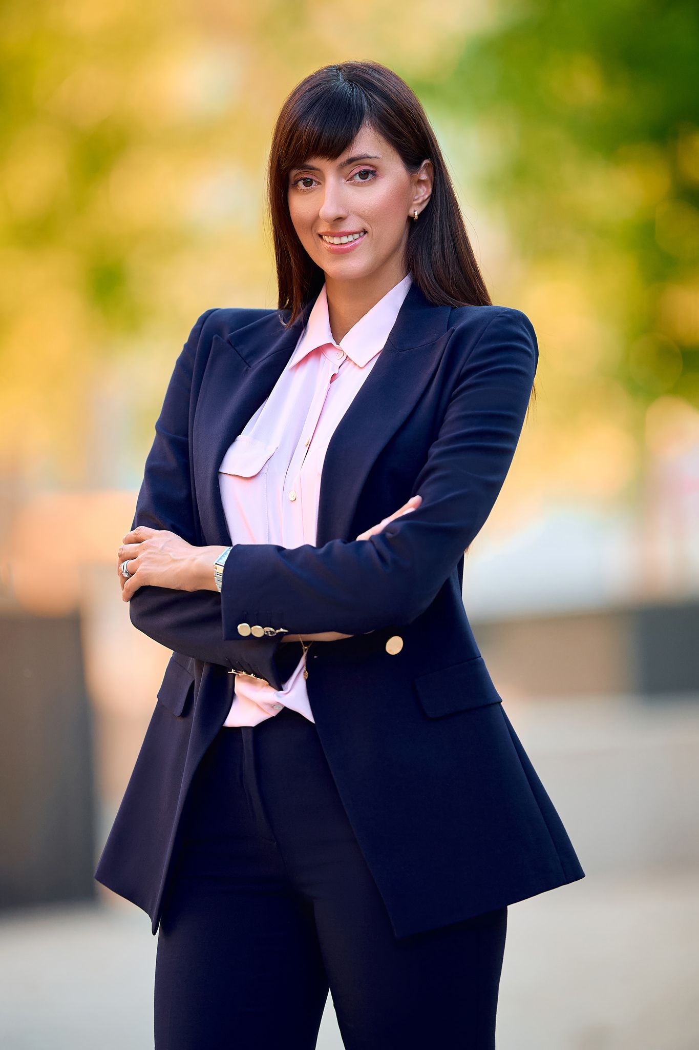 Business portrait poses in a classic navy suit with white blouse.