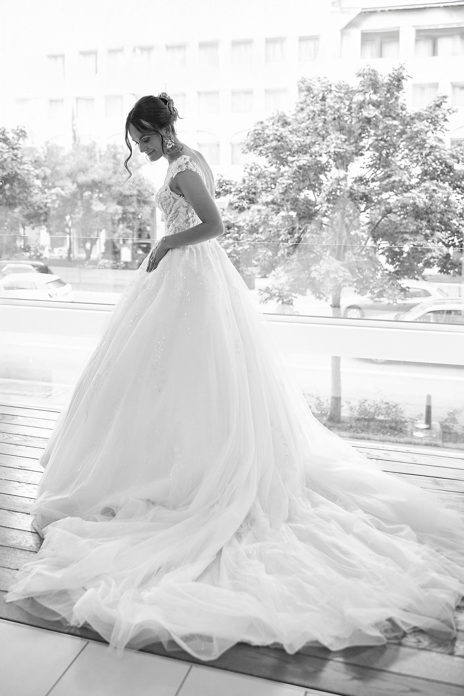 Bride in flowing white ballgown wedding dress photographed in black and white.