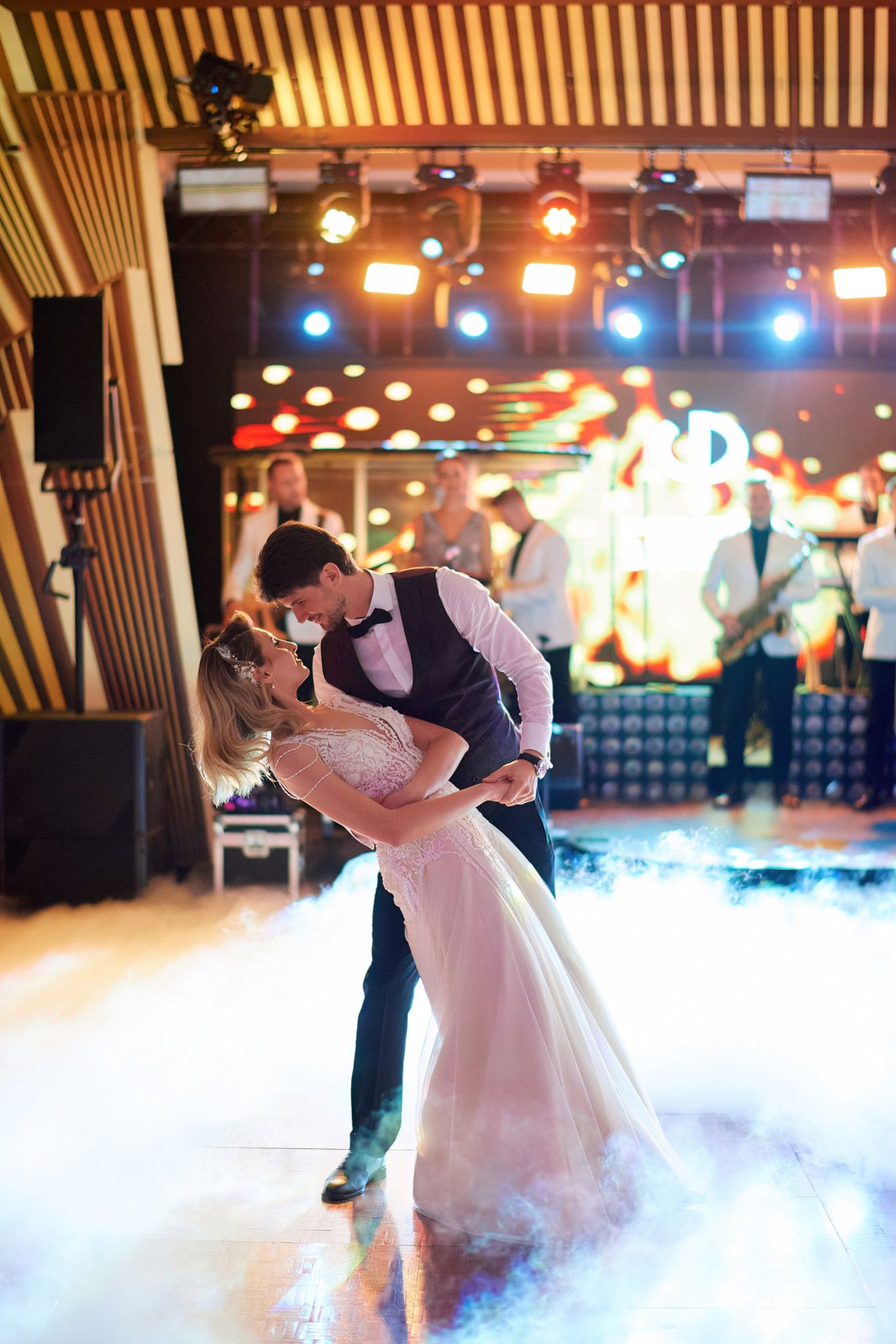 Couple dancing on a misty dance floor with dramatic lighting and theatrical effects.
