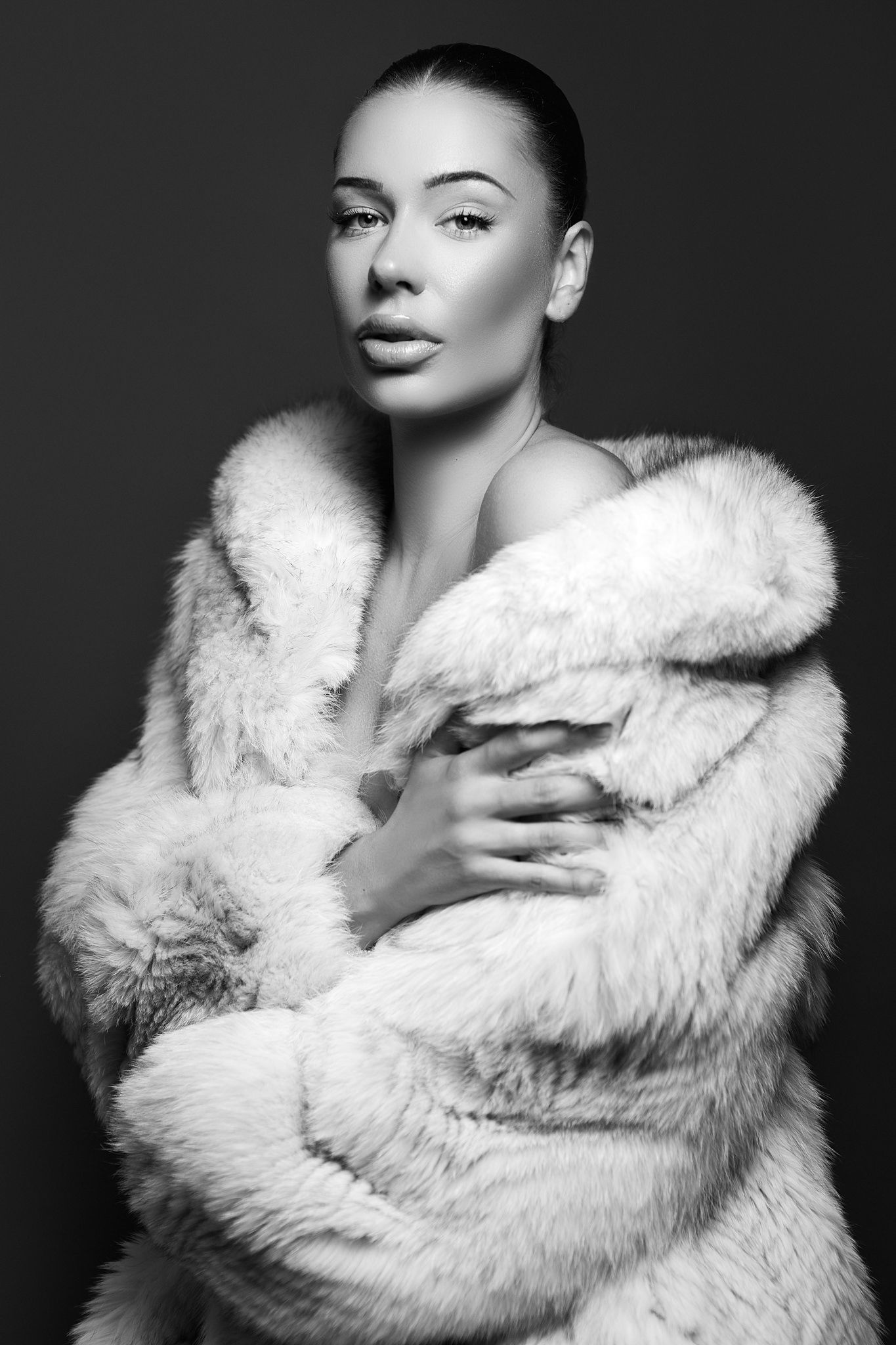 Elegant black and white portrait series in white fur coat.
