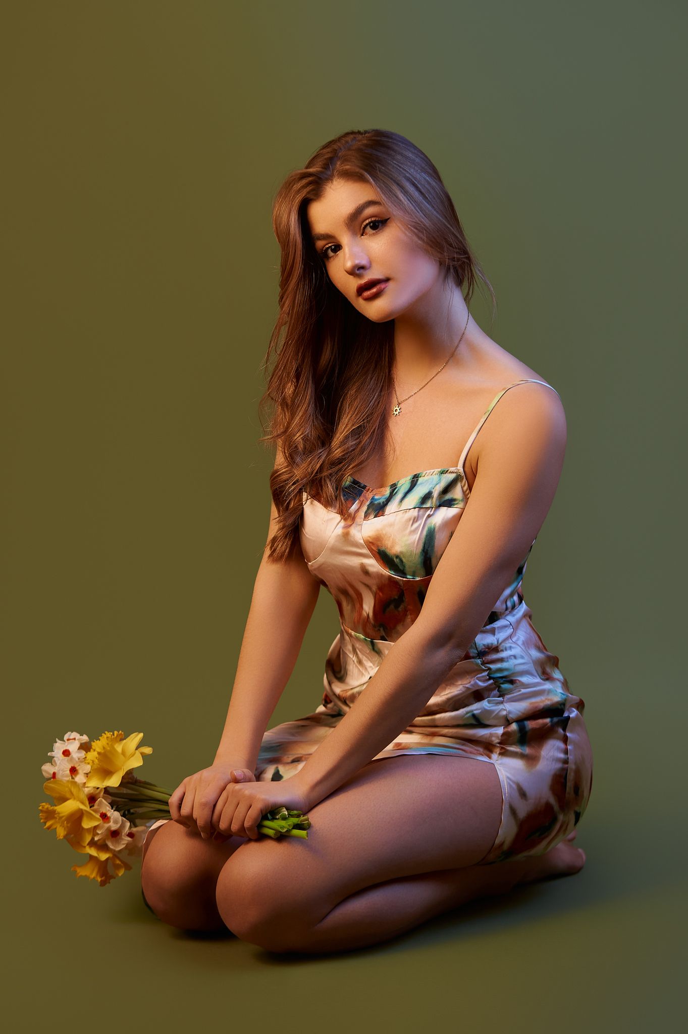 Artistic portrait series with yellow flowers against green background.
