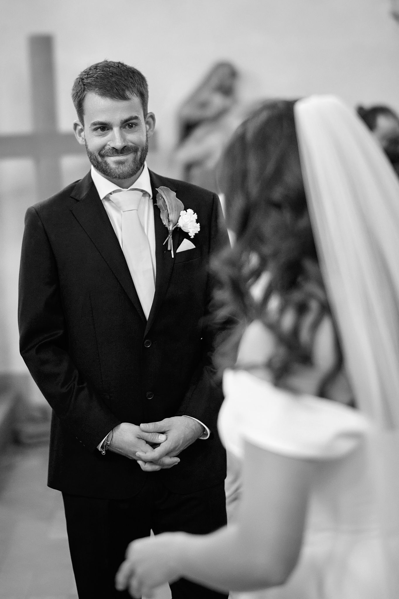 Black and white wedding photos capturing candid emotional reactions during the ceremony.