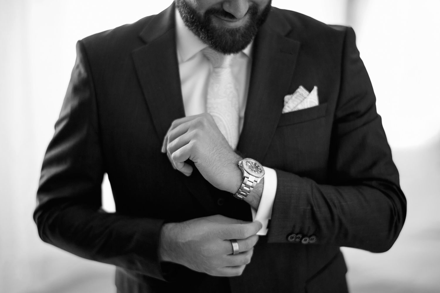 A series of black and white closeup shots showing details of formal wedding attire.