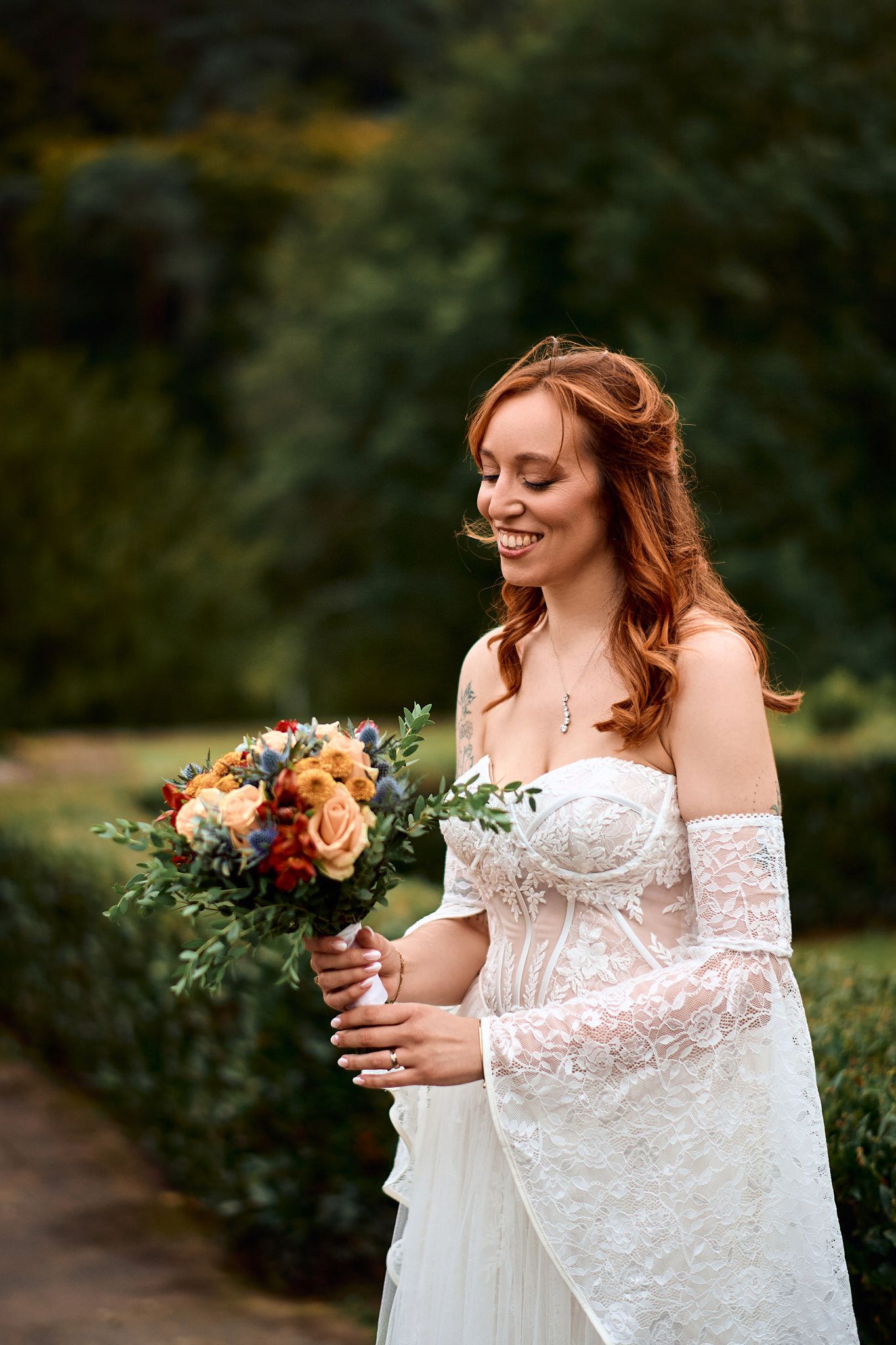 Romantic bridal portraits with autumn-toned bouquet in outdoor garden setting.