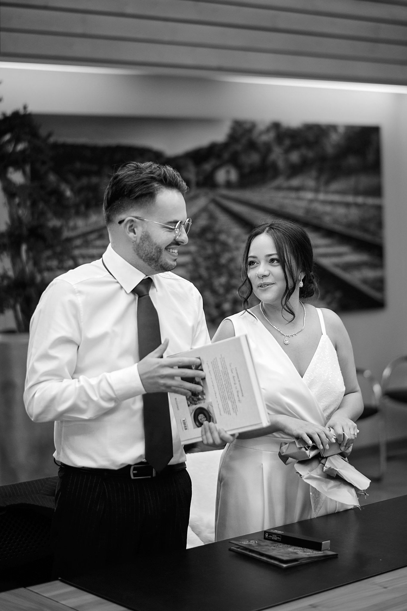 A series of candid black and white photos showing a couple sharing intimate moments at a bar counter.