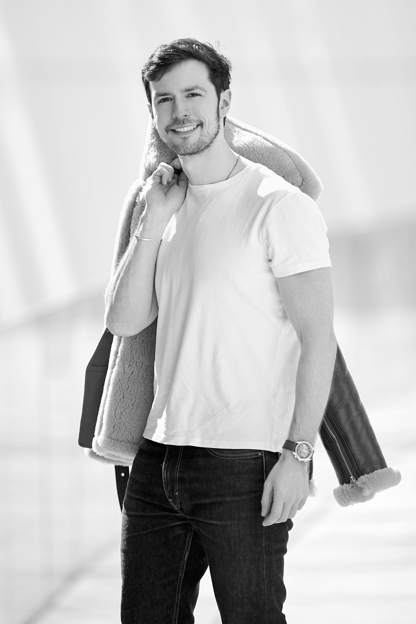Monochrome fashion photos of person in white t-shirt and dark jacket.