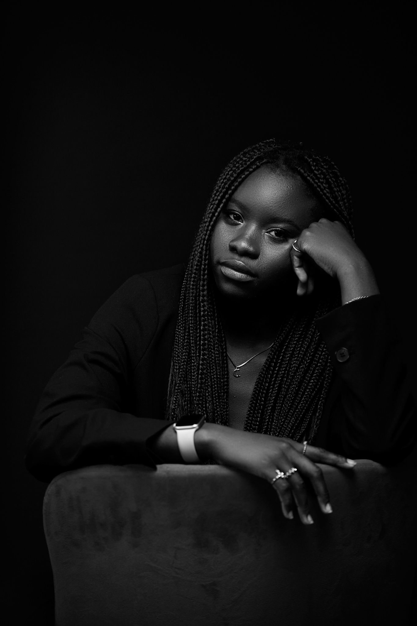 Moody low-key portrait with dramatic lighting and dark tones.
