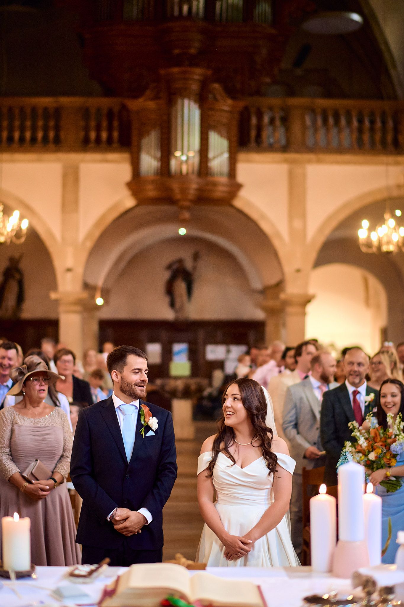 Wedding reception in an elegant venue with arched ceilings and chandeliers.