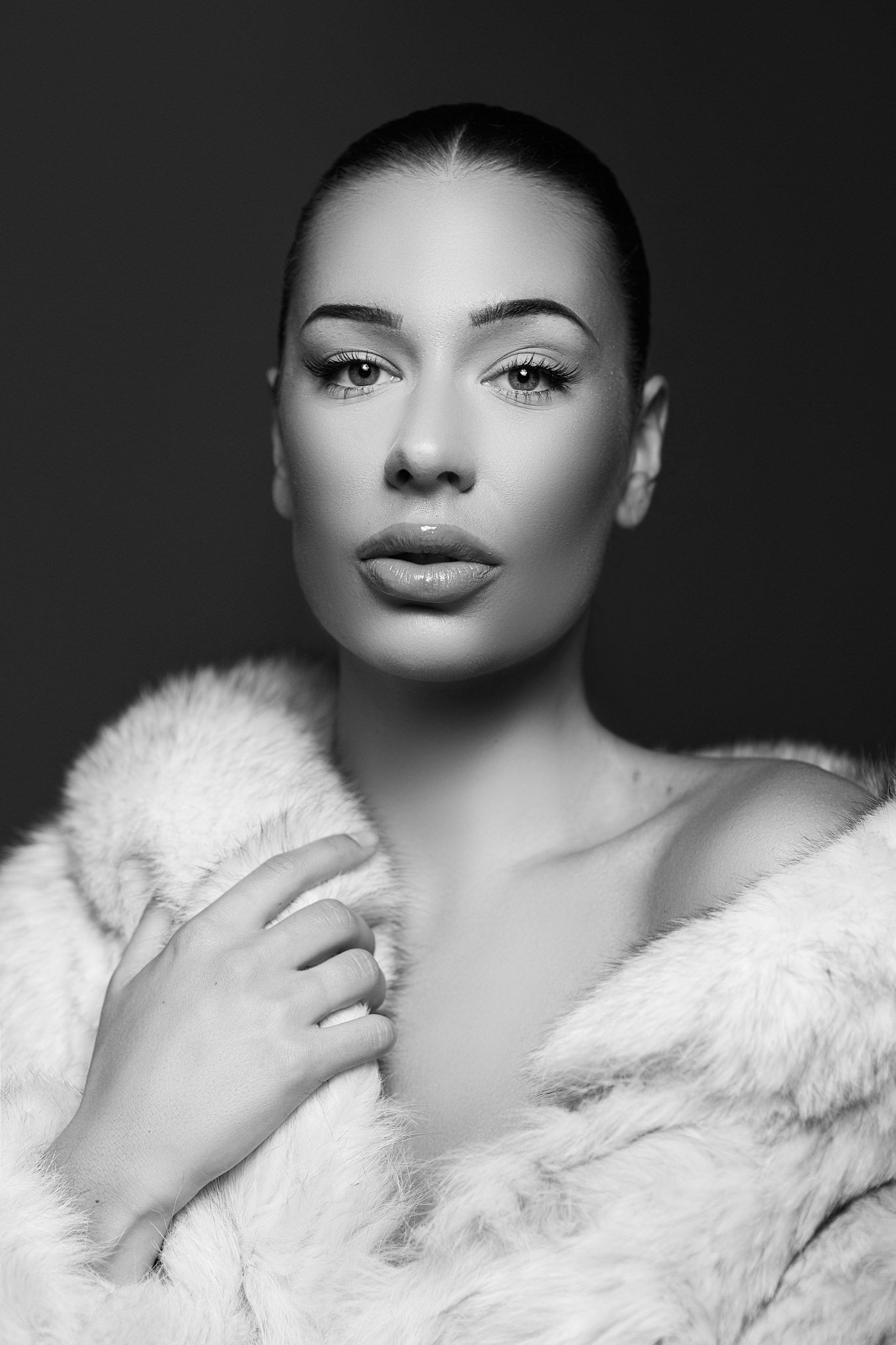 Artistic black and white closeup portraits in white fur coat.