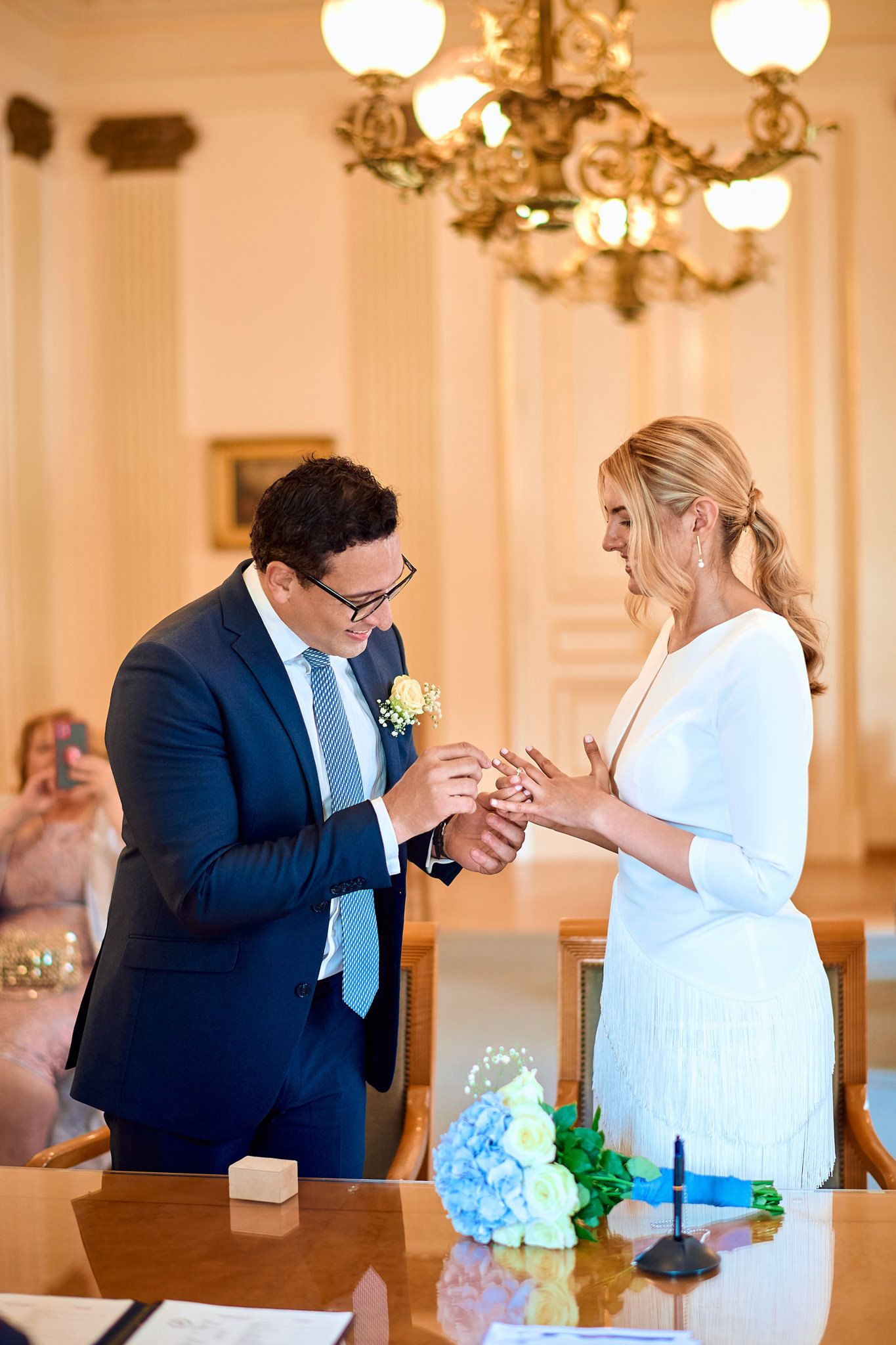 A sequence of wedding photos capturing intimate moments between newlyweds in an elegant ballroom setting.