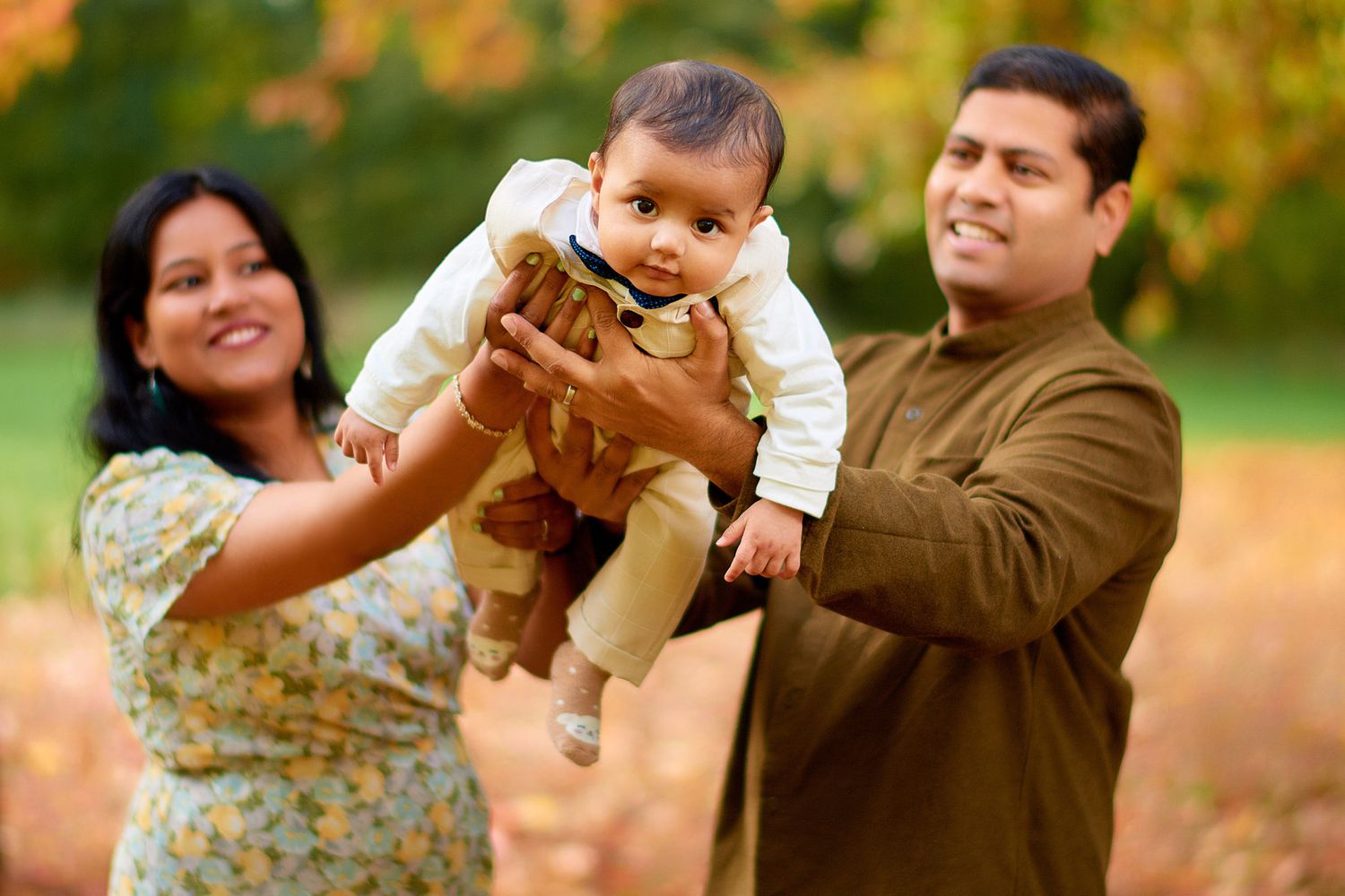 Playful family interactions photographed in a natural outdoor setting during autumn.