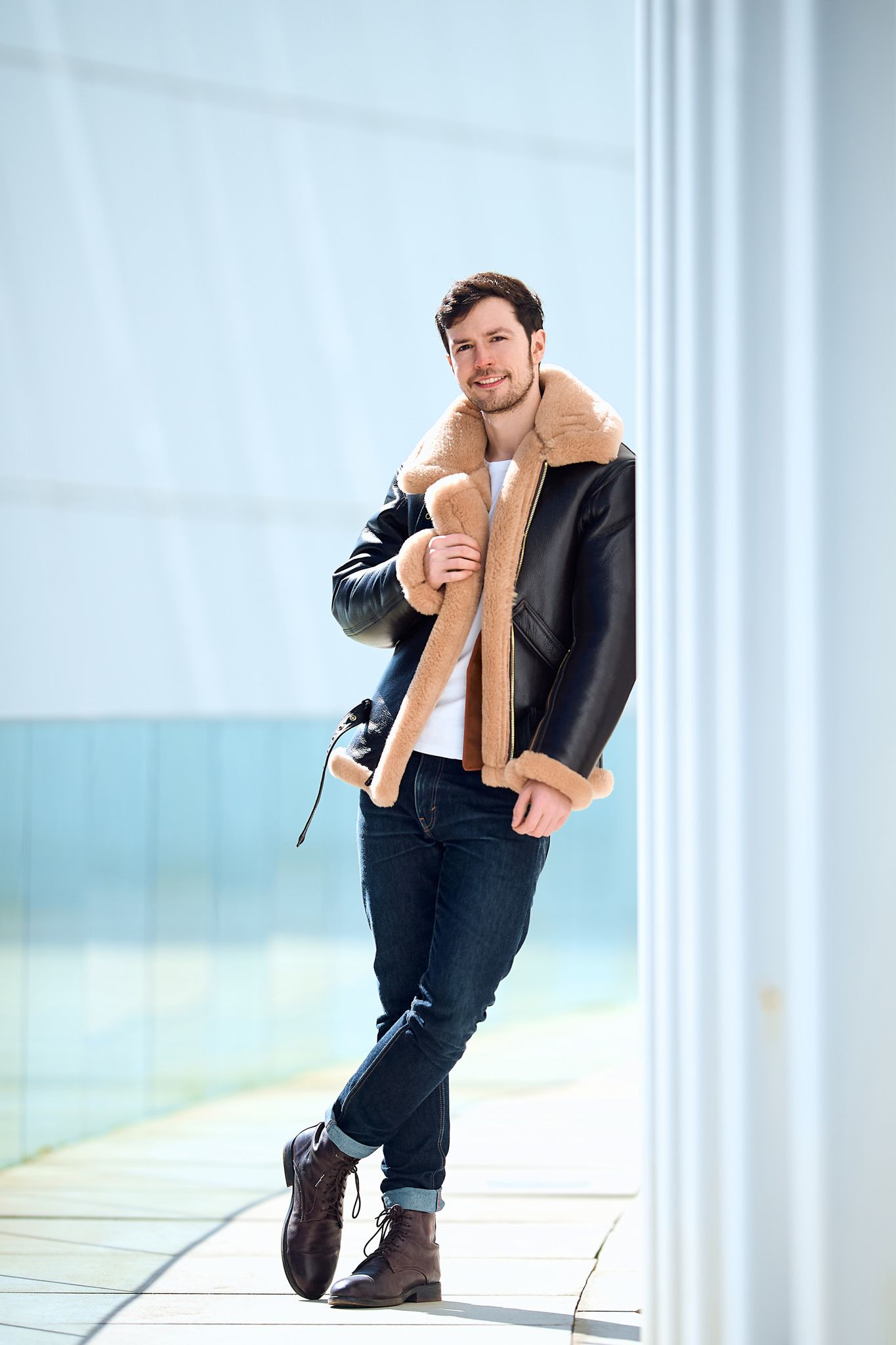 Fashion sequence showing poses in brown jacket against modern interior.