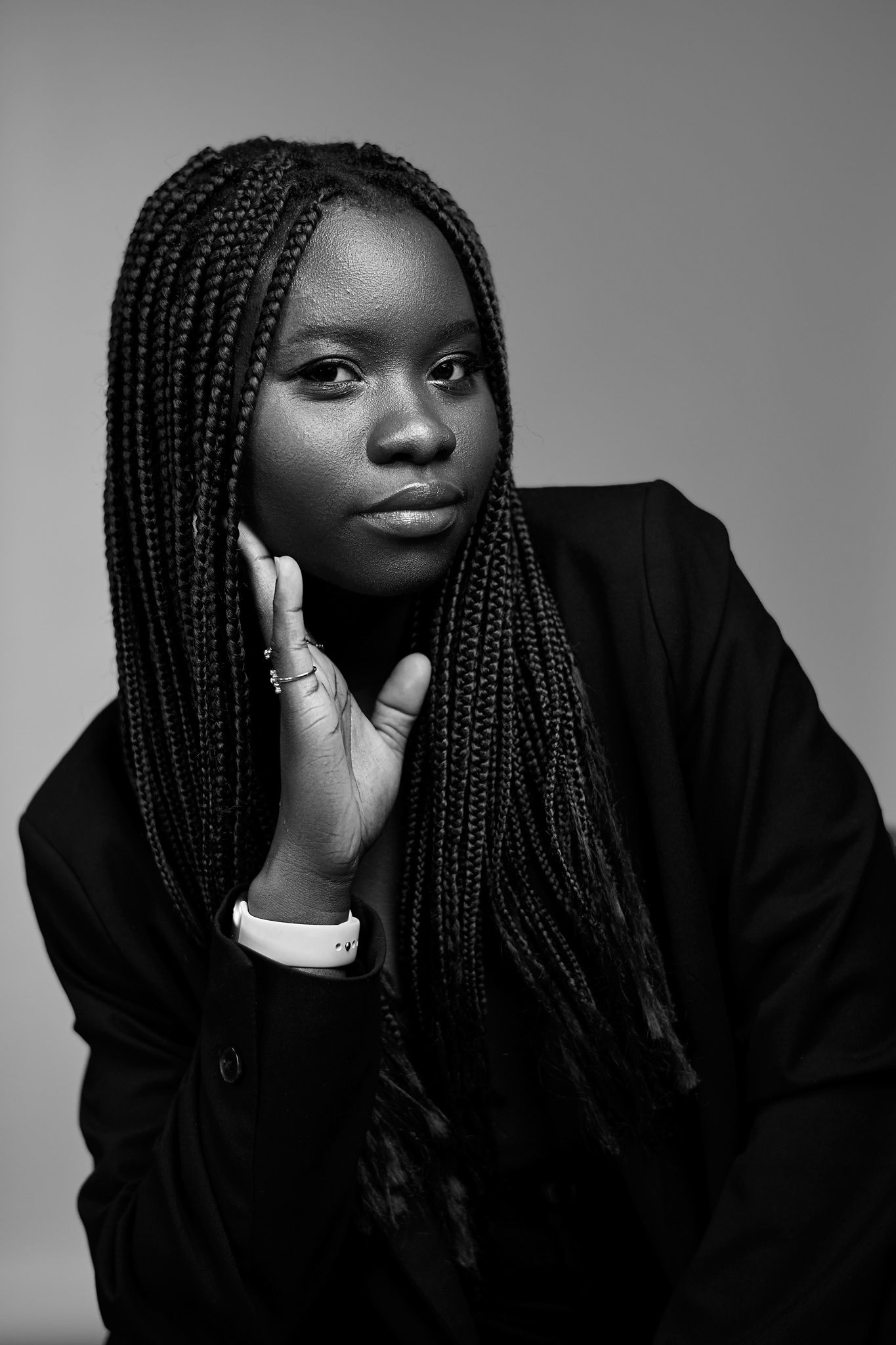 Dramatic black and white portrait with long braids and elegant styling.