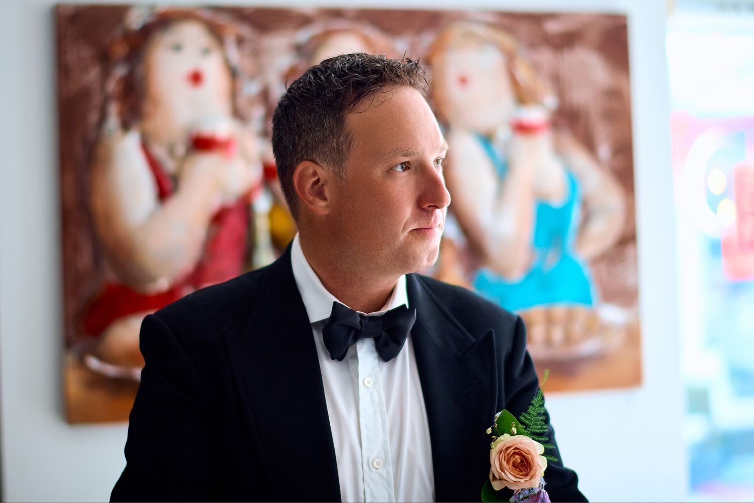 A formal portrait in an elegant indoor setting with classic decor.