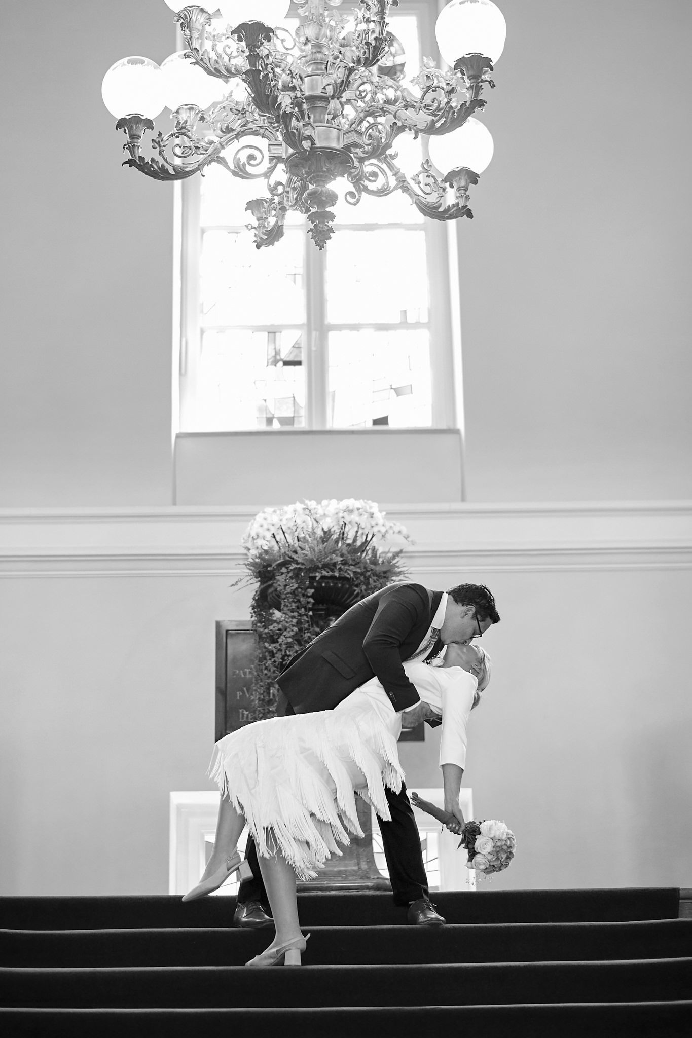 Black and white sequence of a romantic dip pose on stage.