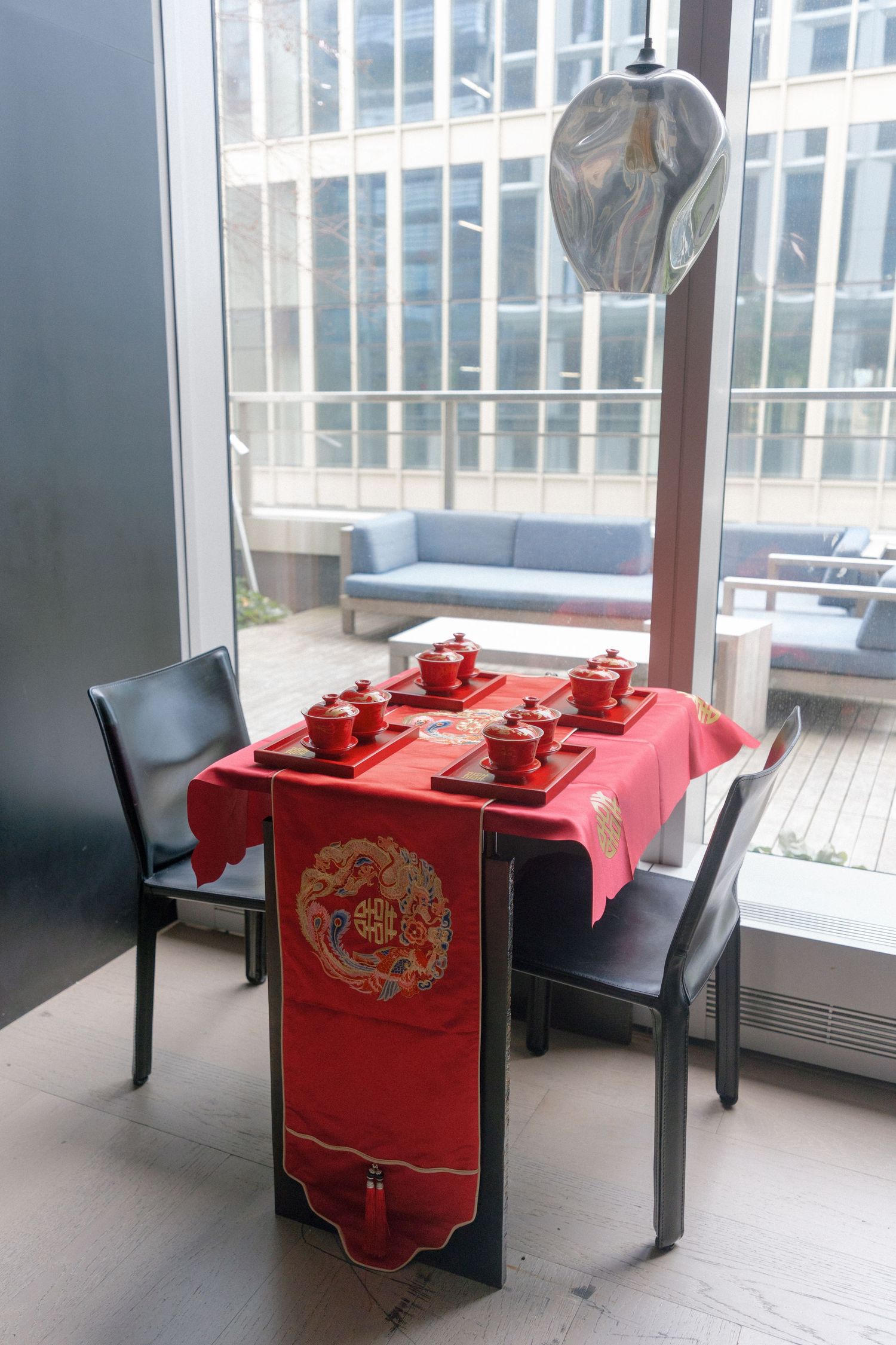 Red Chinese tea ceremony table set with traditional red cups.