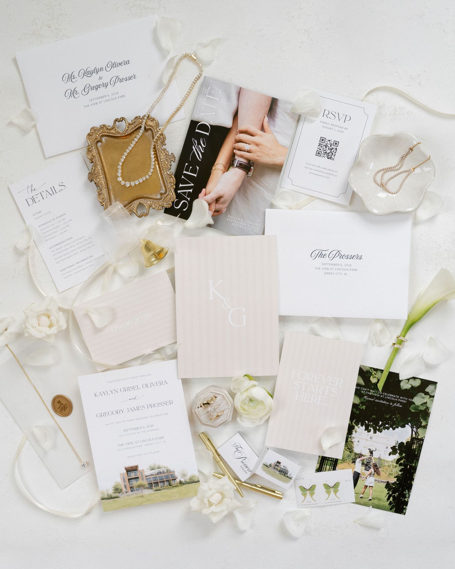 Elegant wedding stationery flatlay with invitations, save the date, and white floral accents.