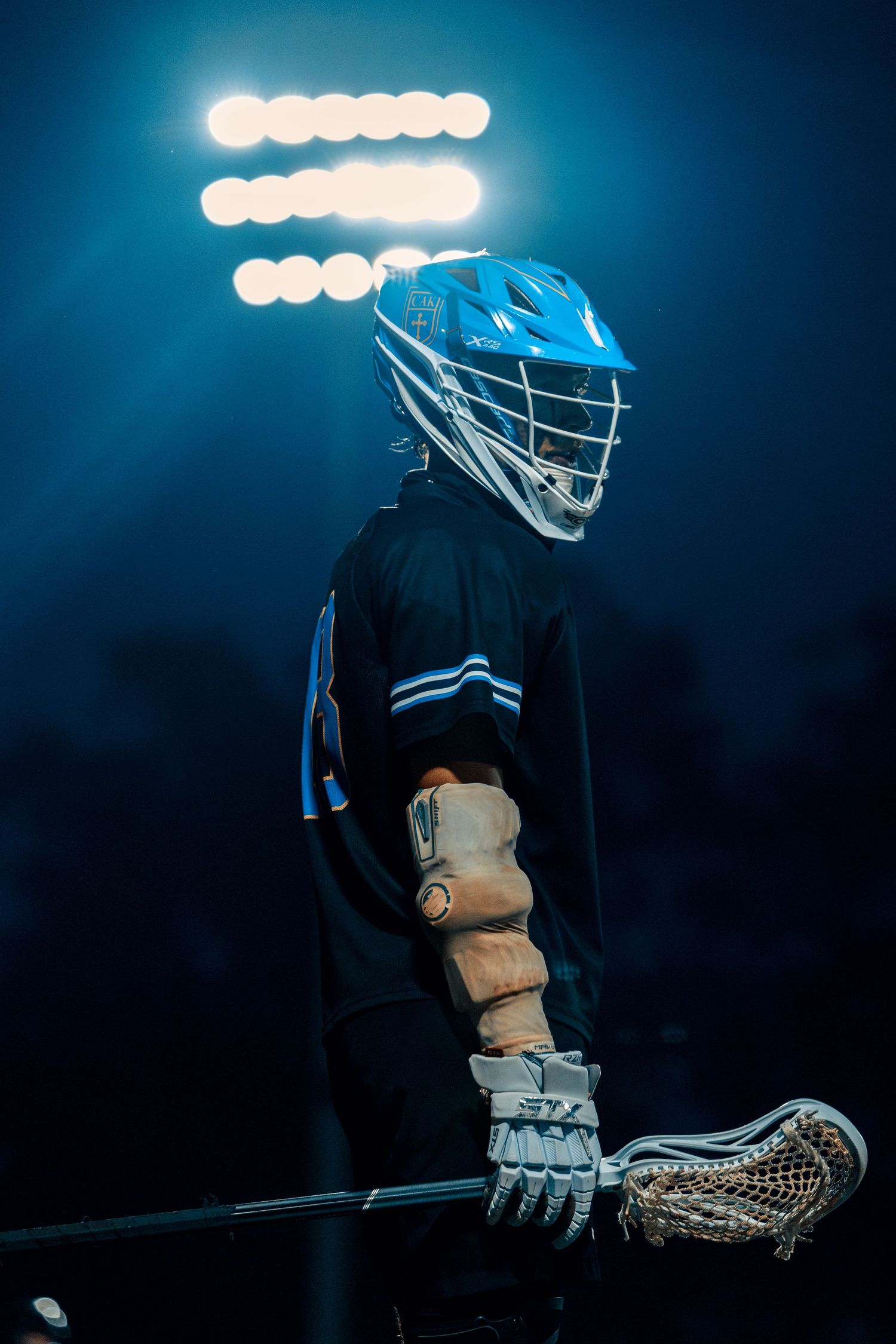Player Ty Slowek stands under the lights during the 4th period against Science Hill High School