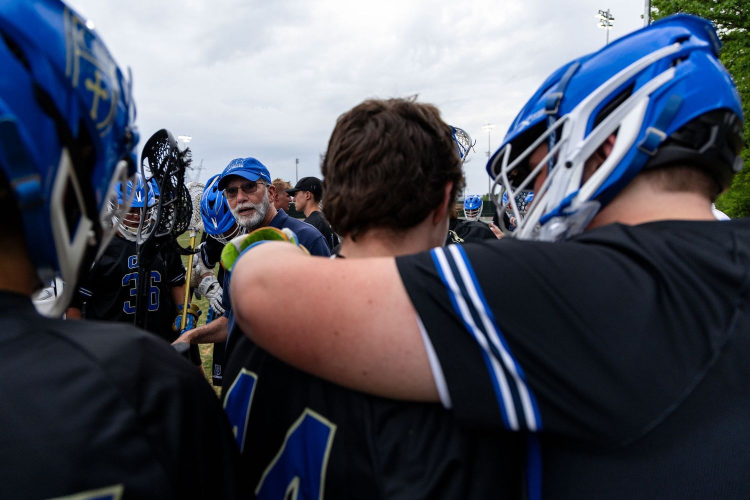 Coach Marty gives a speech to the CAK men's lacrosse defense ahead of their game against USN